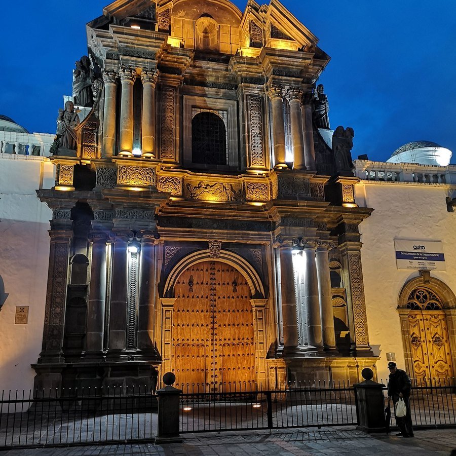 Colonial church facade lit at dusk in Quito