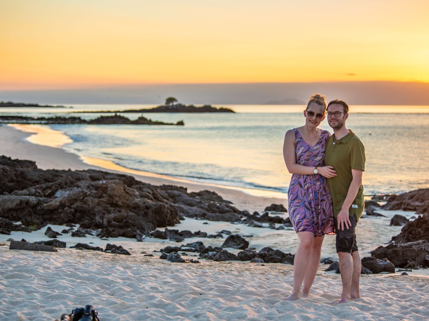 A couple at sunset on a Galápagos beach
