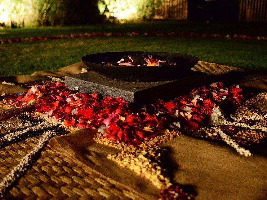 An Andean ceremony laid out in rose petals and grain