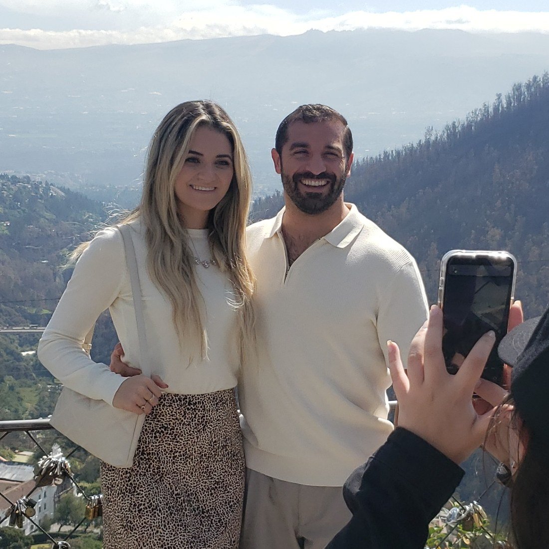 A couple photographed by their guests at a lookout over the Andes